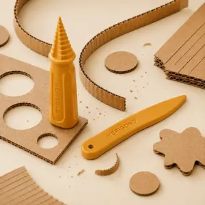 plastic knife and drill bit with the cardboard scraps lying around